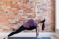 young-woman-in-yoga-position-against-exposed-brick